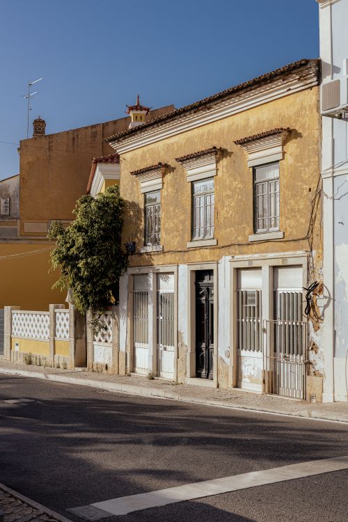 Free Historic yellow building in Loulé, Faro, Portugal on a sunny day. Stock Photo