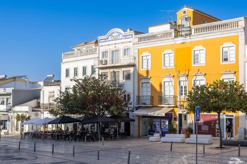 Free Explore the vibrant architecture and inviting outdoor cafes in a picturesque square in Loulé, Faro, Portugal. Stock Photo