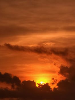 Captivating orange sunset with dramatic clouds over Chattogram, Bangladesh.