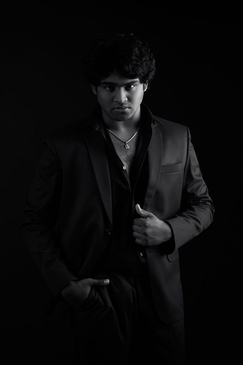 Free Artistic black and white portrait of a confident man in formal attire. Ideal for dramatic themes. Stock Photo
