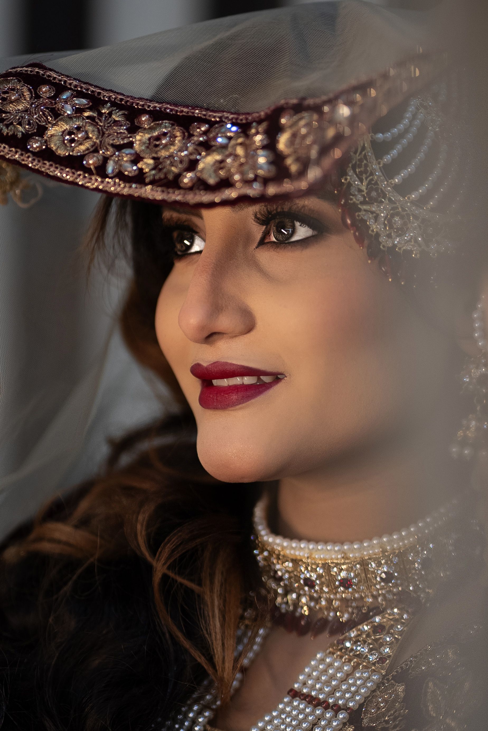 Close-up portrait of a bride in ornate traditional attire, exuding elegance and cultural richness.