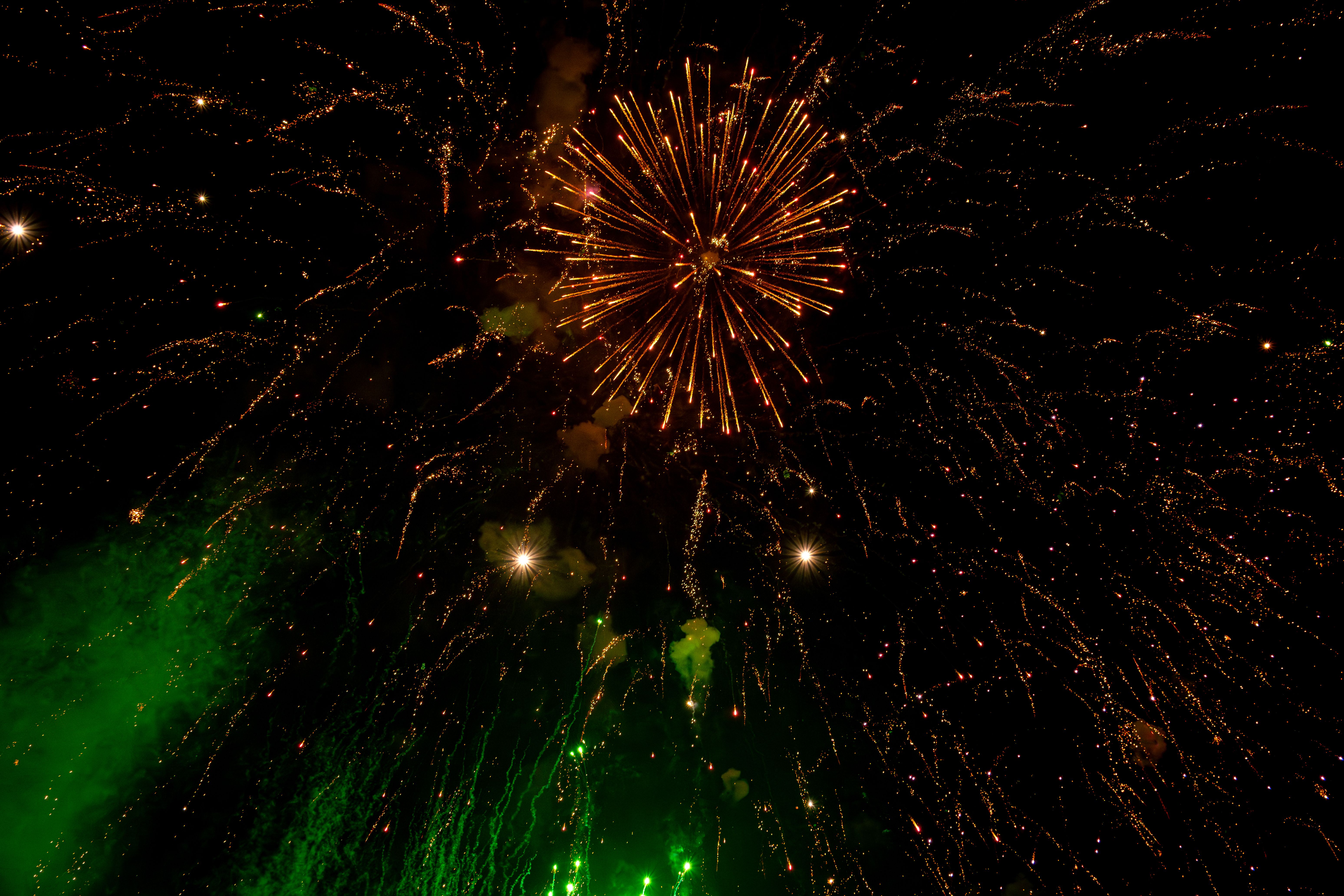 Dazzling fireworks burst with bright colors illuminating the night sky in a mesmerizing display. — Trójmiasto