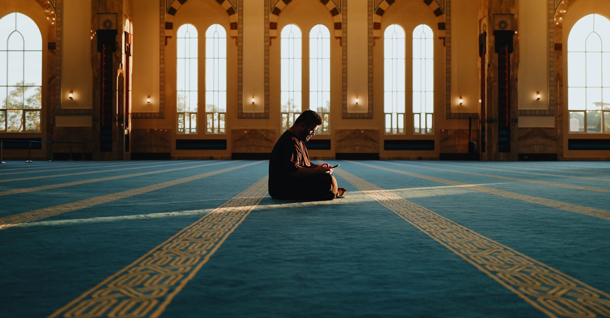A person meditating in the tranquil setting of Sendayan Mosque, Malaysia.