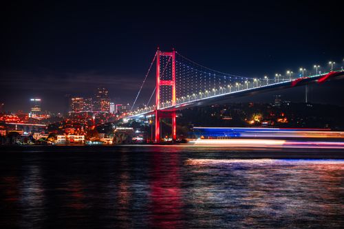 Free Colorful night shot of the Bosphorus Bridge in Istanbul, showcasing city lights and reflections. Stock Photo