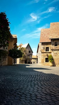 Explore the quaint architecture and charming streetscape in Dubai under clear blue skies.