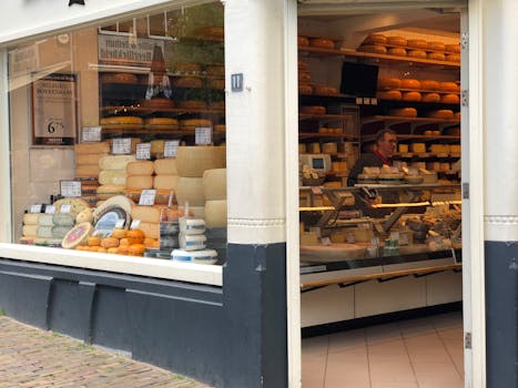 A charming Utrecht cheese shop with a vendor and artisan cheeses on display.