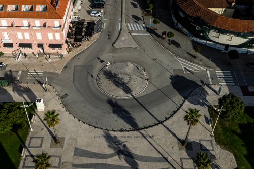 Free Aerial shot of a city roundabout with surrounding architecture and streets, showing urban planning. Stock Photo