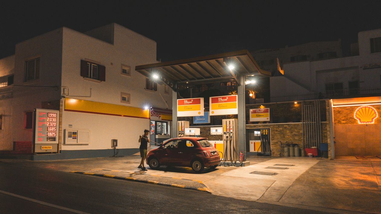 Driver refueling a car at night