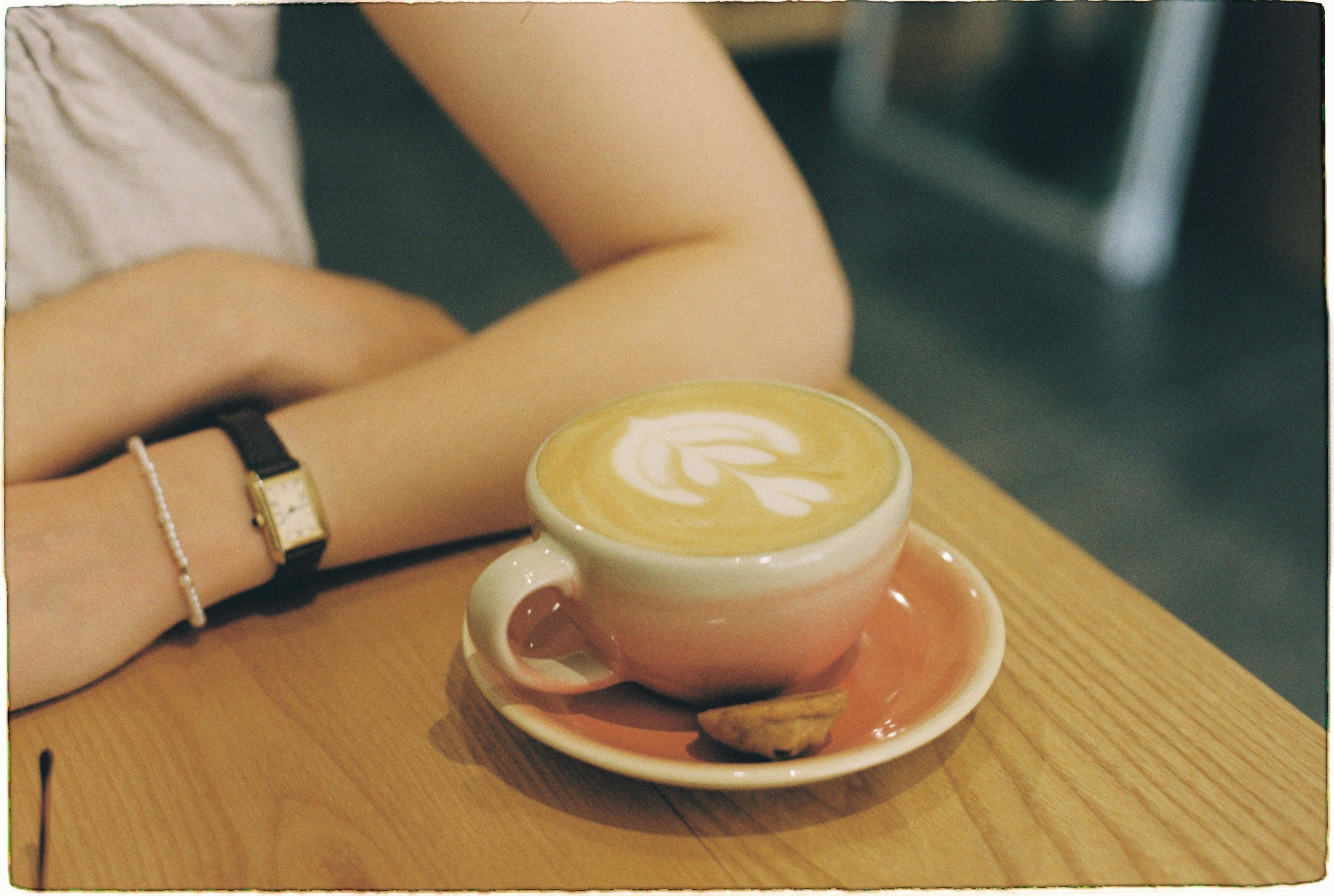 A young congregation member holding a coffee cup at the Christ Embassy Ho Loveworld Arena café area