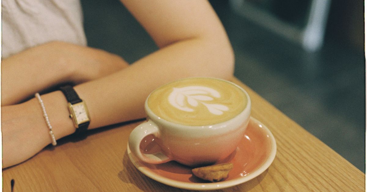 A young congregation member holding a coffee cup at the Christ Embassy Ho Loveworld Arena café area