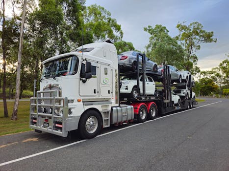 Large car carrier truck transporting vehicles on a road in Heathwood, Queensland.