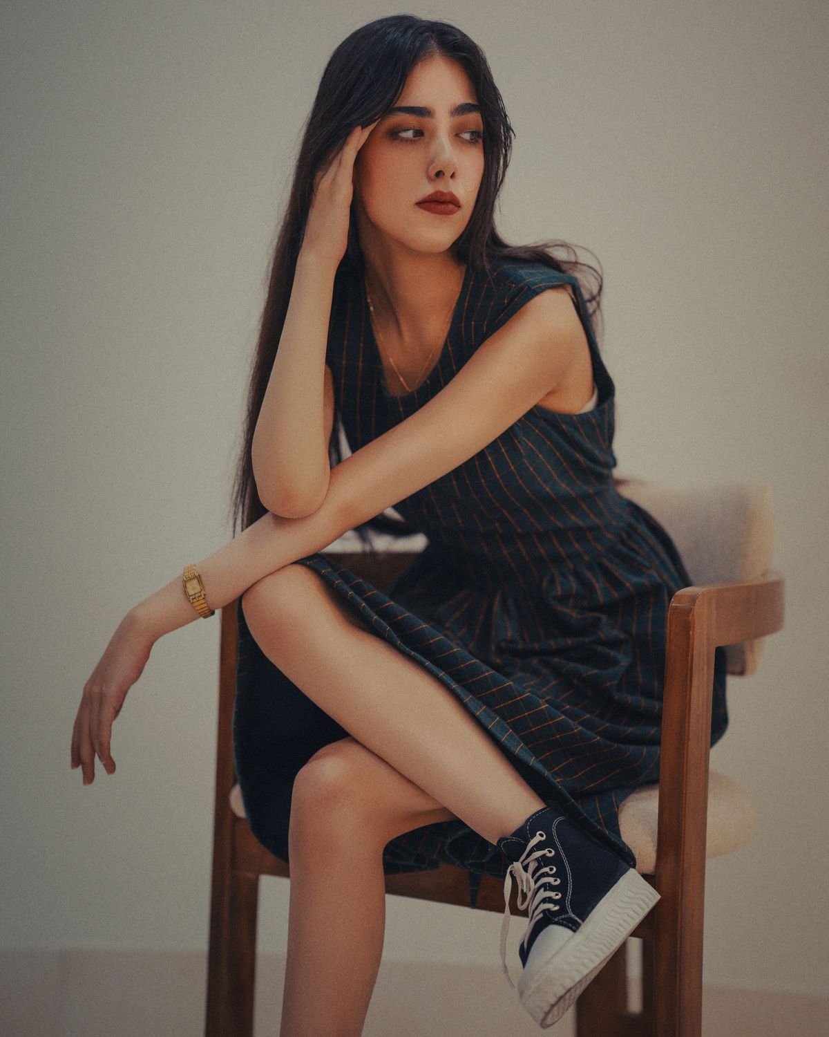 Elegant Woman Seated Indoors in Fashion Portrait · Free Stock Photo