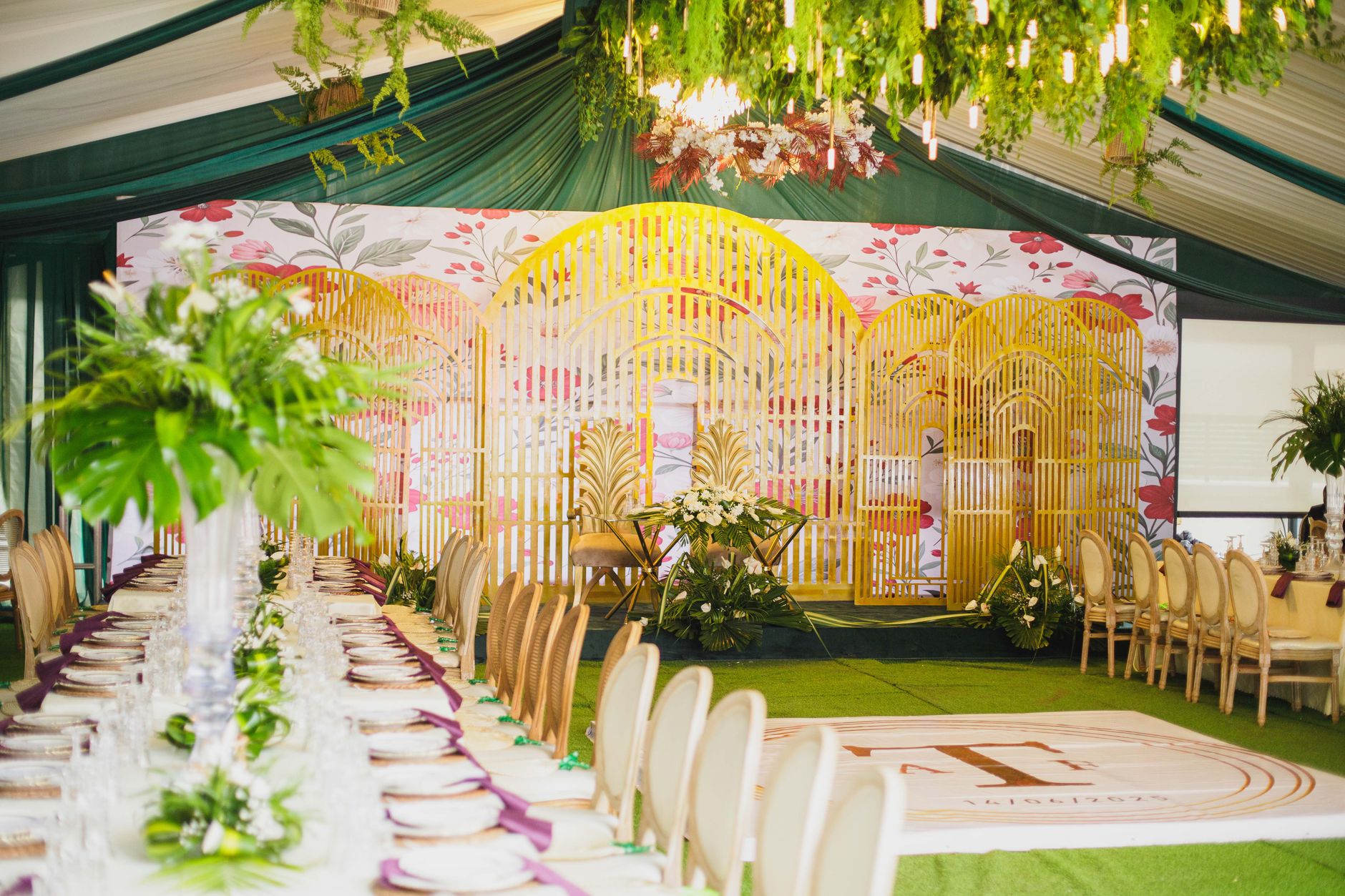 Luxurious indoor wedding reception with decorative floral design and elegant dining setup.