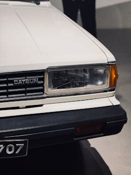 Close-up shot of a vintage Datsun car featuring its distinctive headlight design.