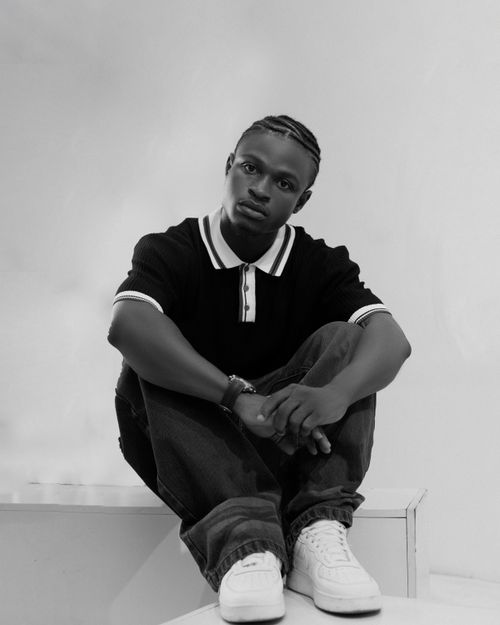 Free Black and white portrait of a young man seated, exuding a thoughtful expression. Stock Photo