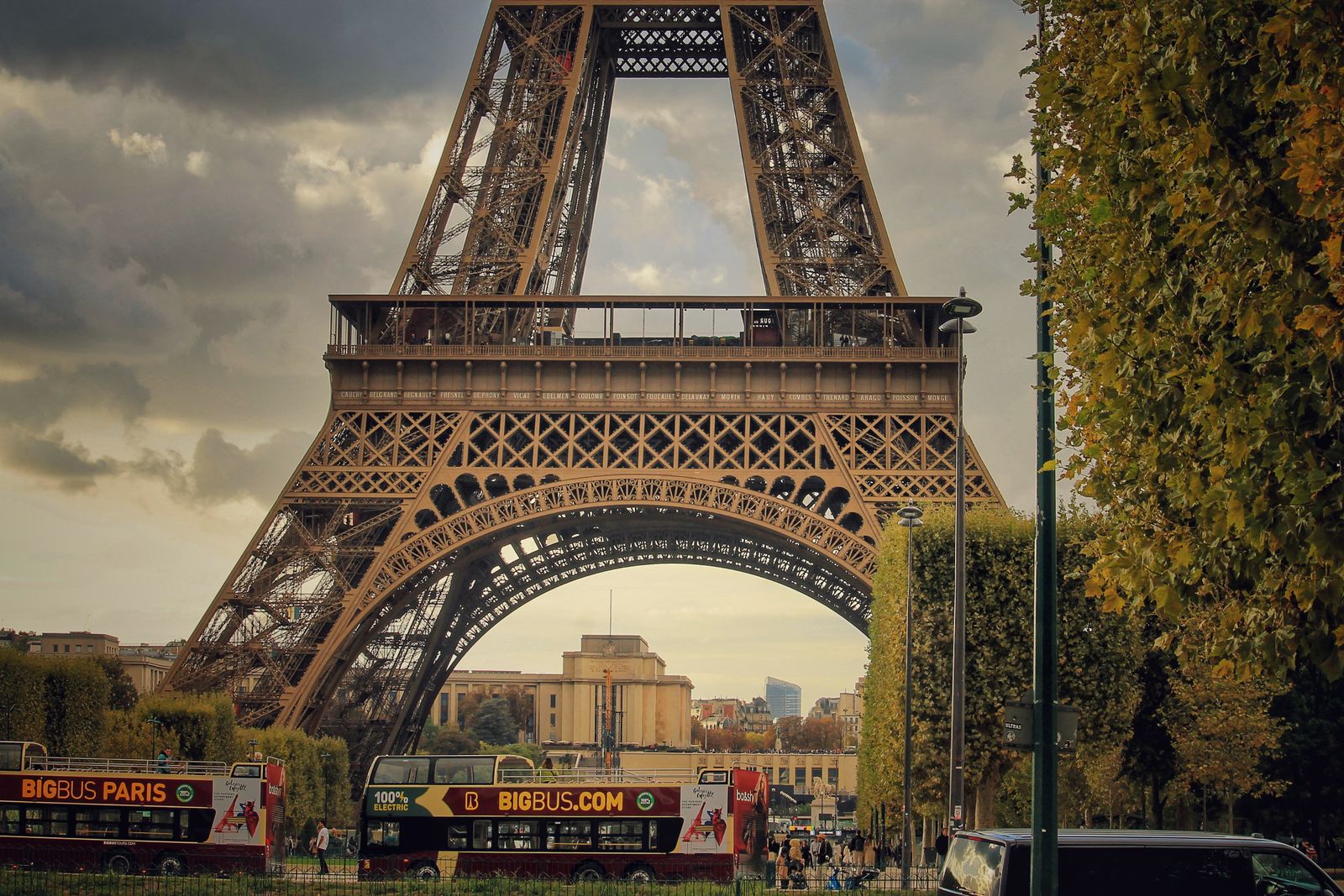 Paris City Tour bus with Eiffel Tower at dusk