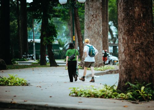 Free Casual stroll in a lush park in Ho Chi Minh City, Vietnam, capturing urban nature's tranquility. Stock Photo