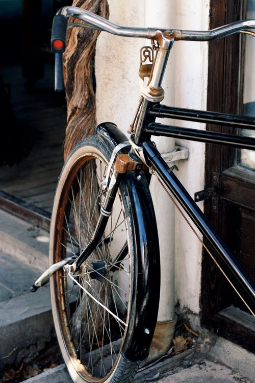 Free An old-fashioned bicycle rests against a rustic wall in the charming district of Beypazarı, Ankara. Stock Photo