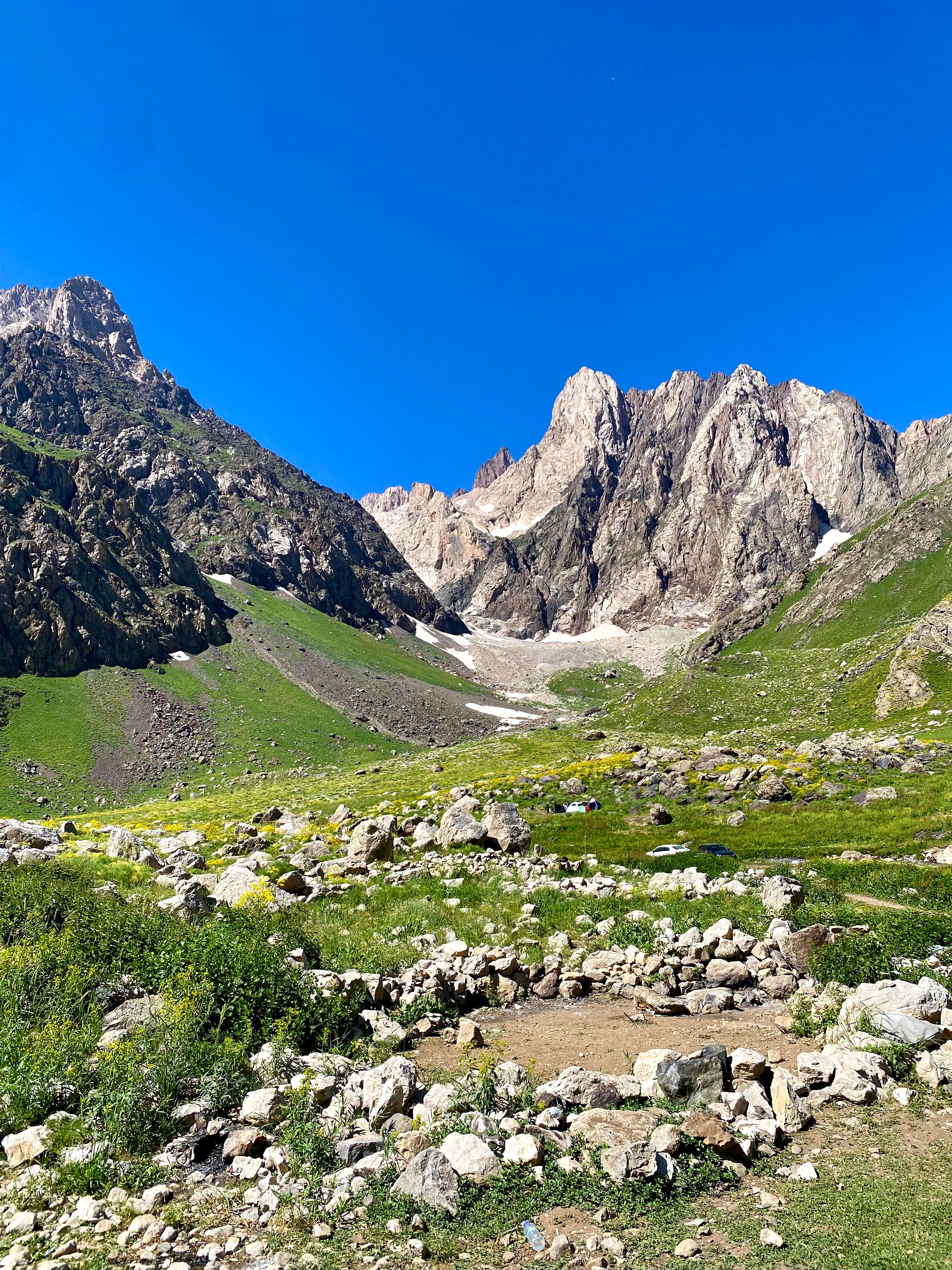 Explore the serene and majestic mountain landscape on a clear summer day.