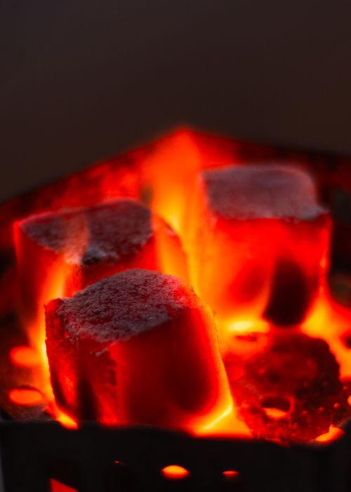Free Intense close-up of red-hot charcoal briquettes, glowing with heat and ready for grilling. Stock Photo