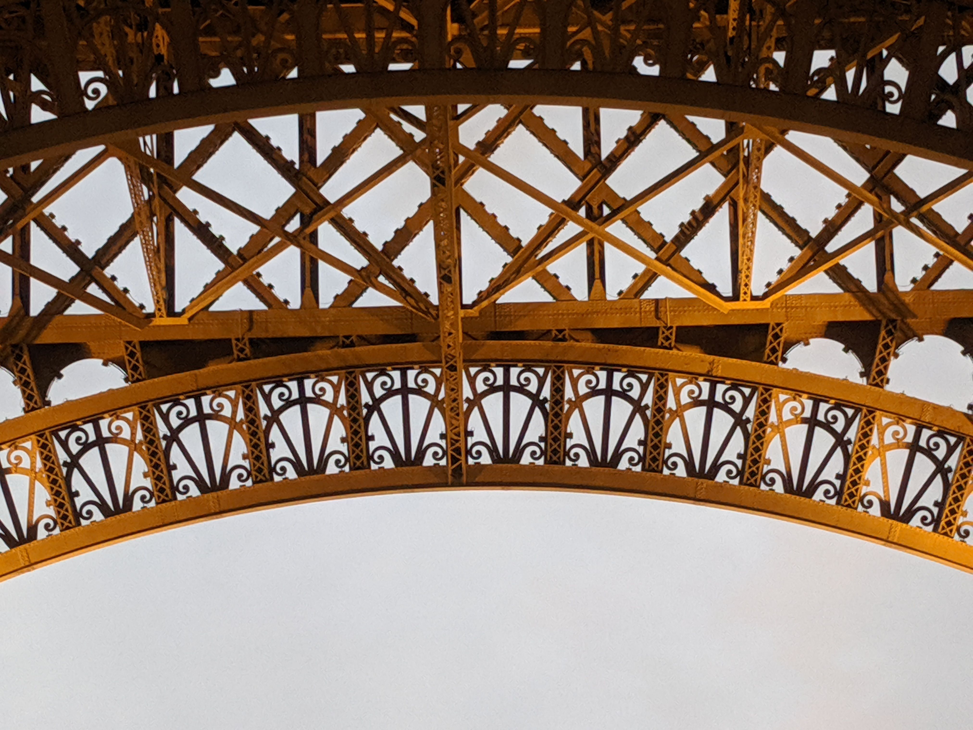 Intricate iron lattice architectural details of the Eiffel Tower in Paris, France.
