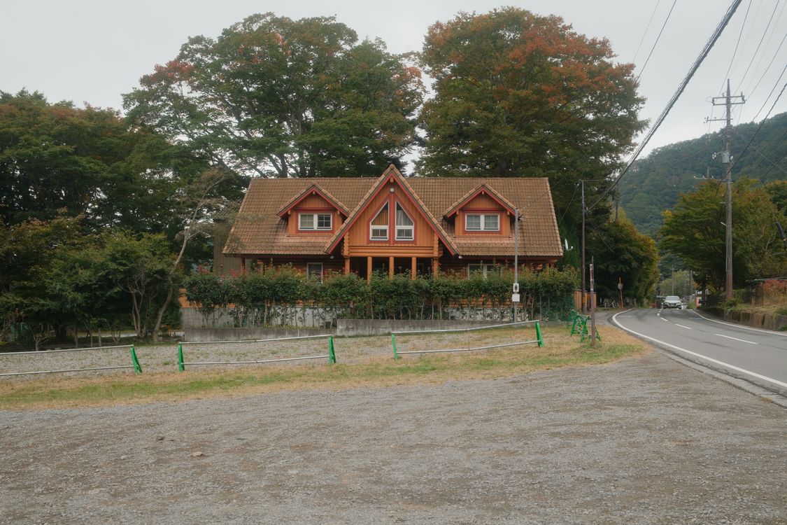 A free-standing two-storey wooden detached house beside a quiet lane in Japan