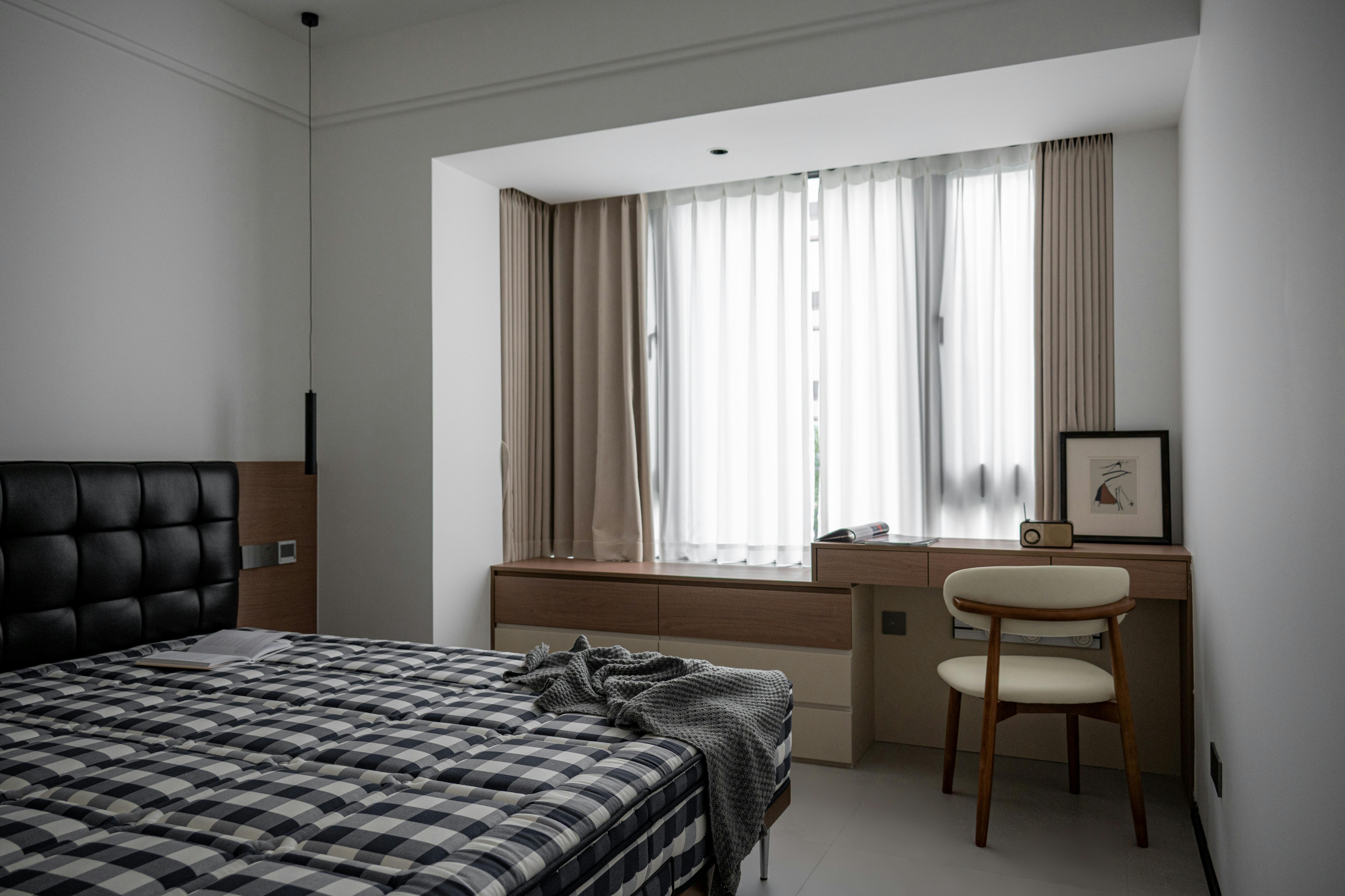 A serene and clean patient room in a detox center, with natural light and comfortable furnishings - detox facilities near me