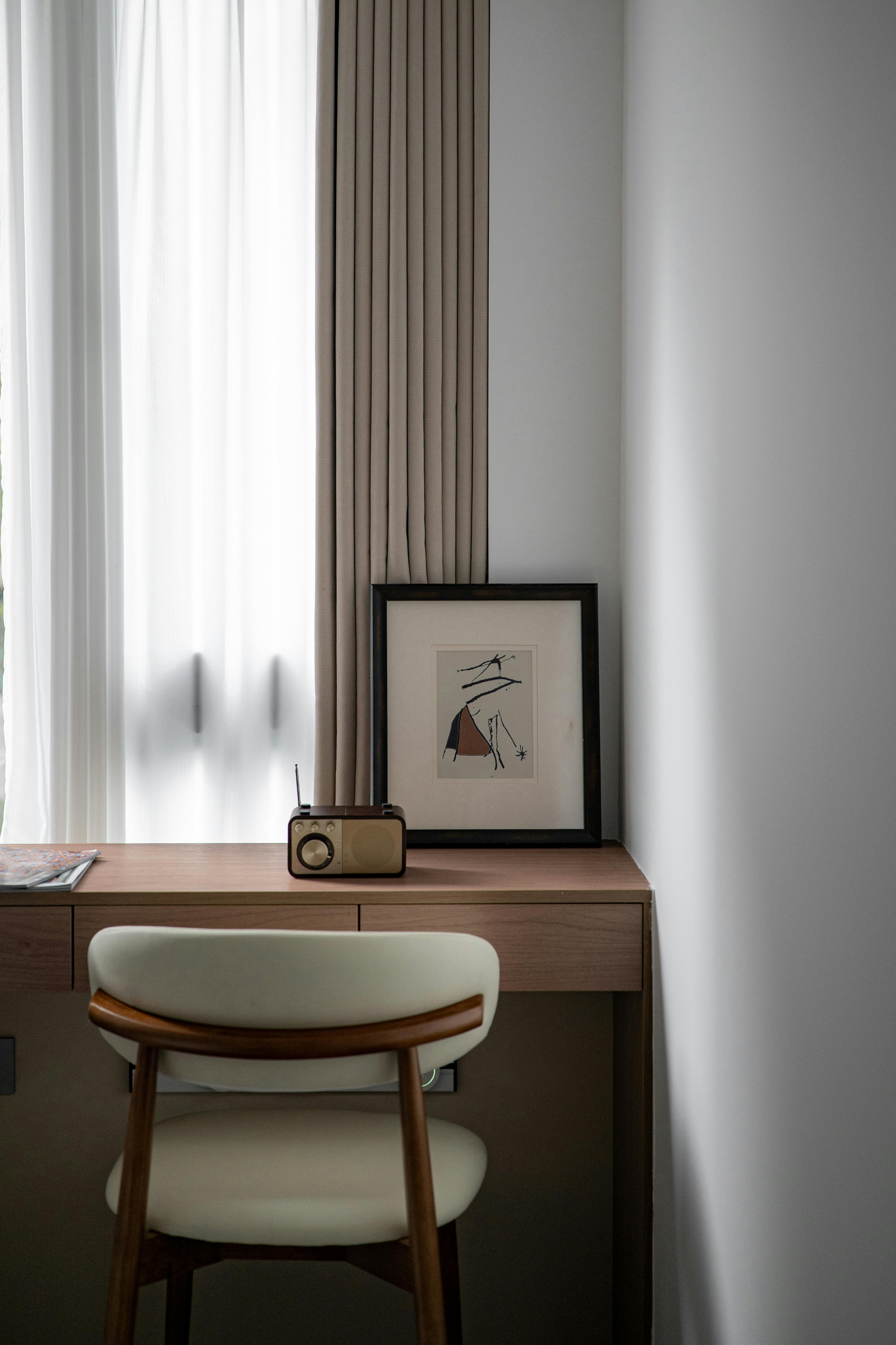 Stylish workspace featuring a mid-century chair and vintage radio.