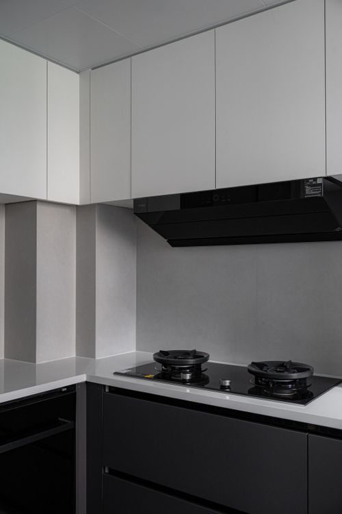 Free Sleek and modern kitchen with black cabinetry and white countertops, showcasing minimalist design. Stock Photo