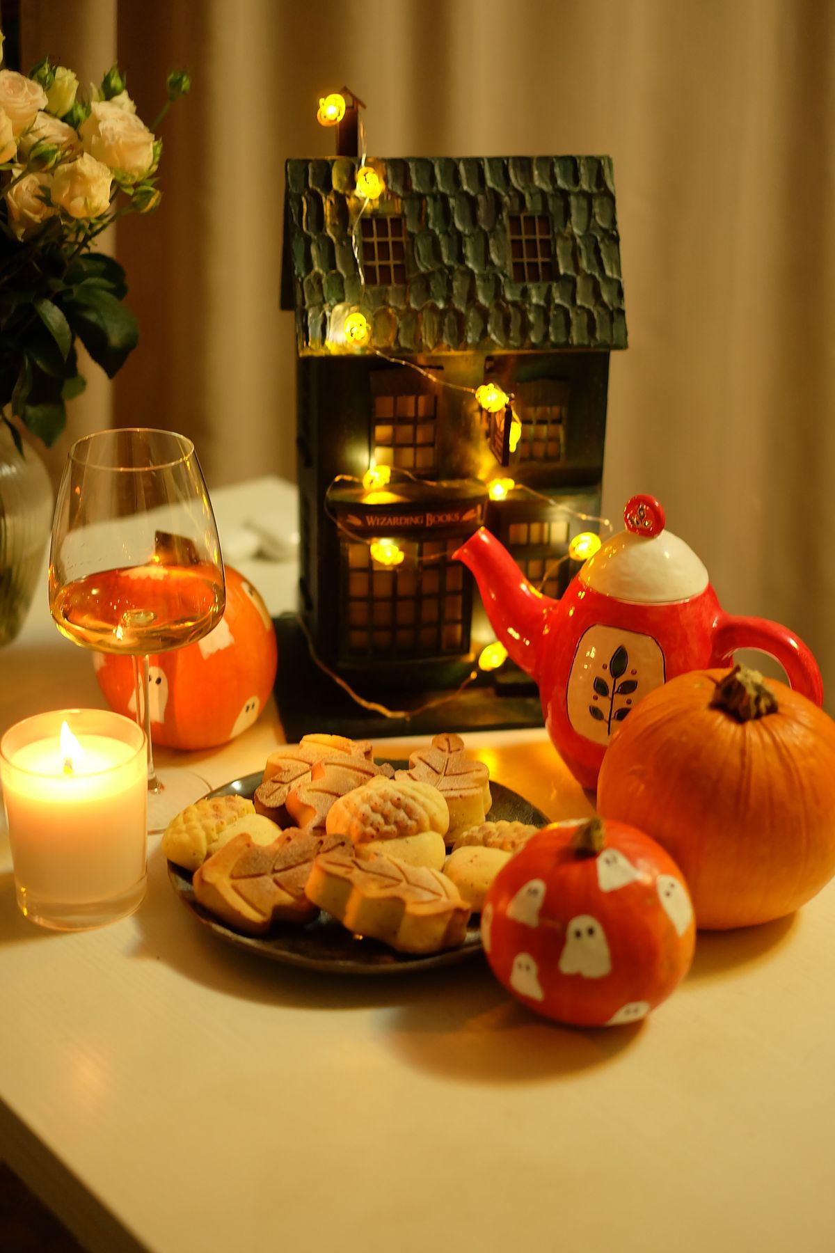 Warm Halloween table setting with pumpkins, cookies, and festive decorations