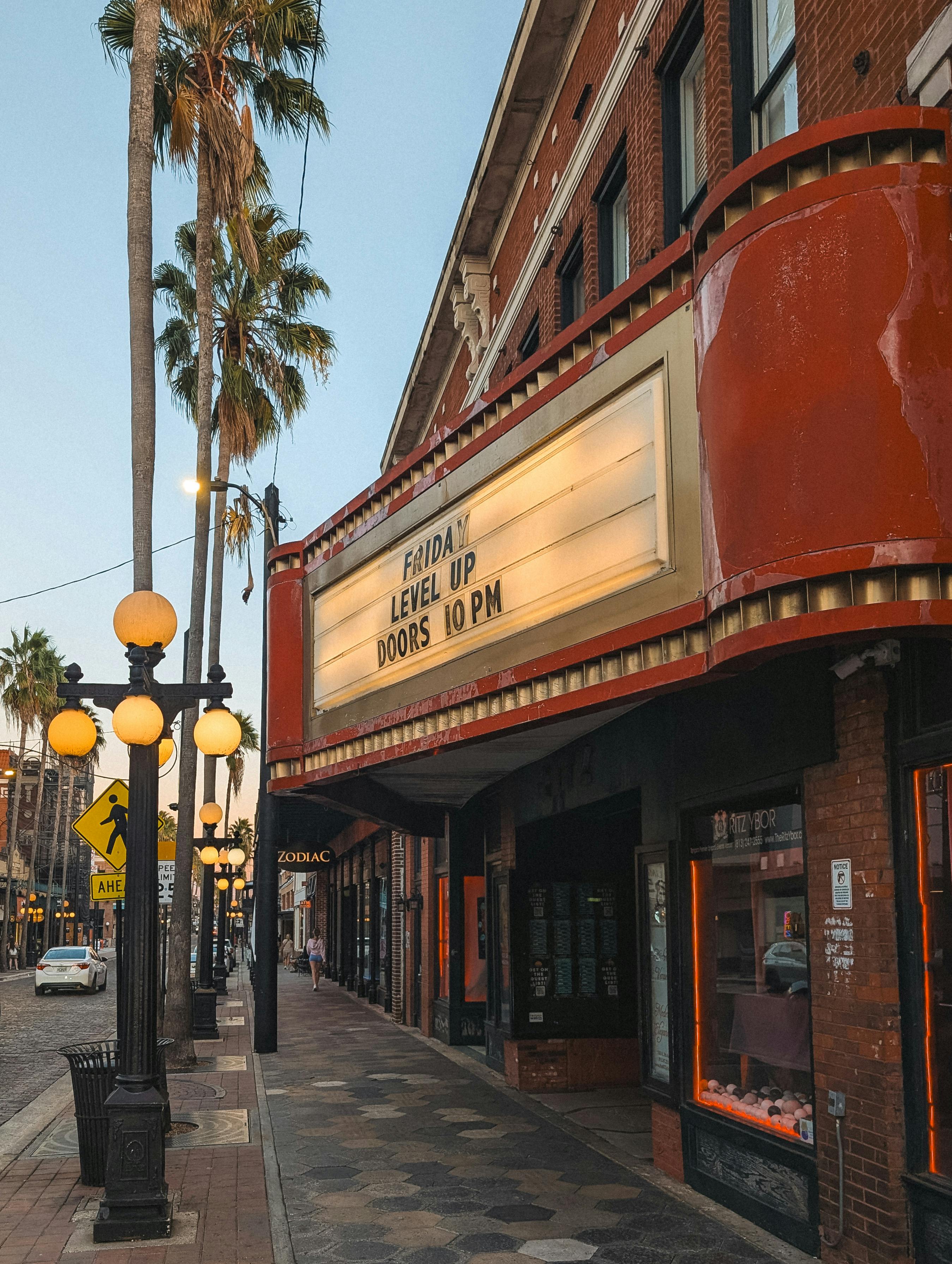 Free Capture of a classic Tampa theater at sunset, highlighting its vintage architecture and bustling street vibe. Stock Photo