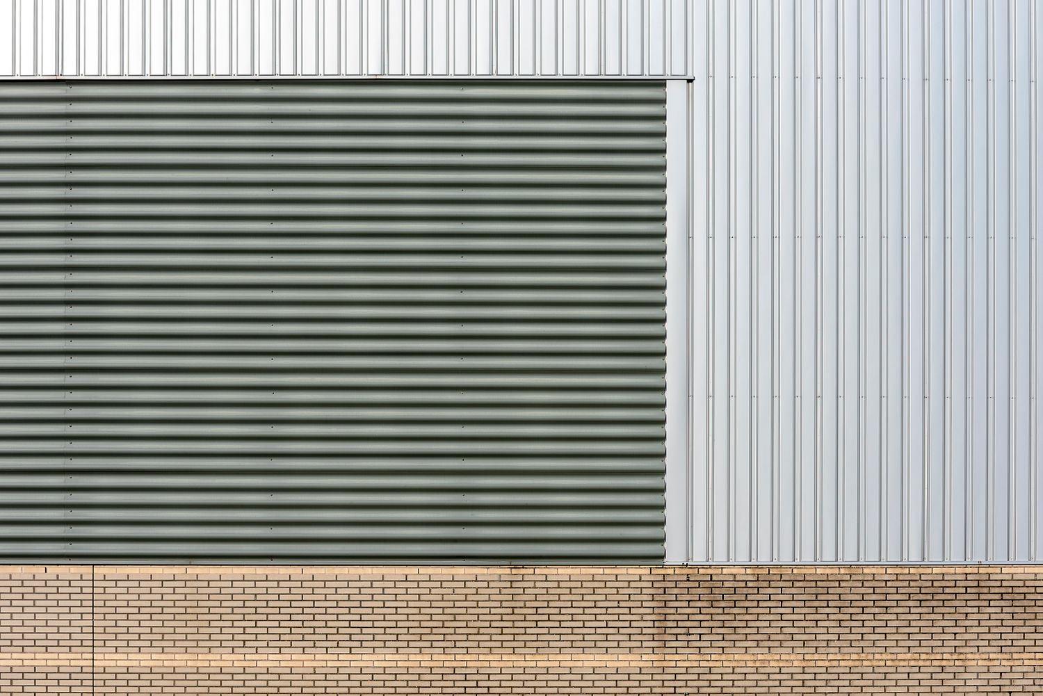 The corrugated-metal and brick facade of an industrial building