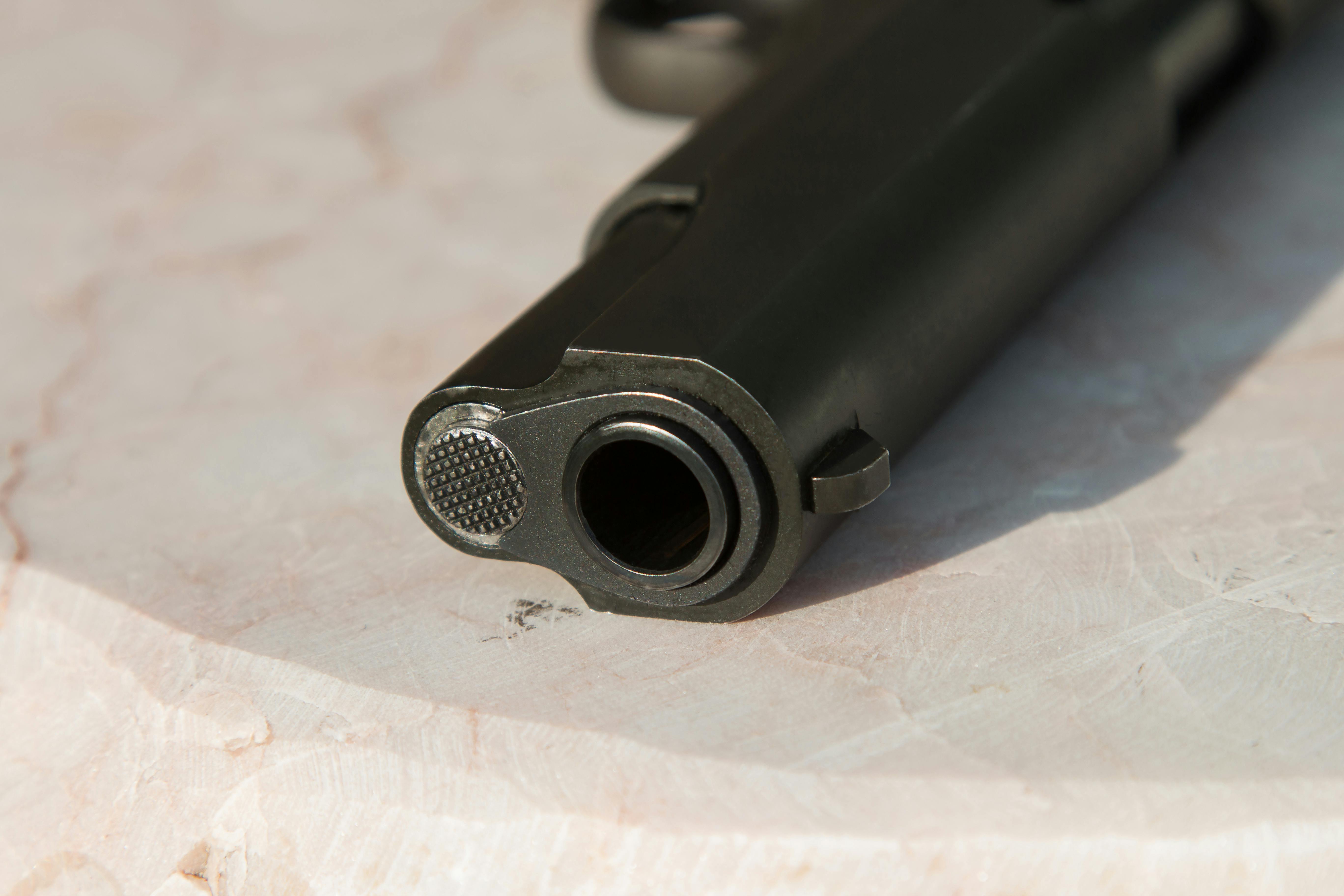 black-metal-gun-on-white-surface-free-stock-photo