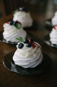 Delicious mini Pavlova topped with berries, perfect for gourmet dessert lovers.