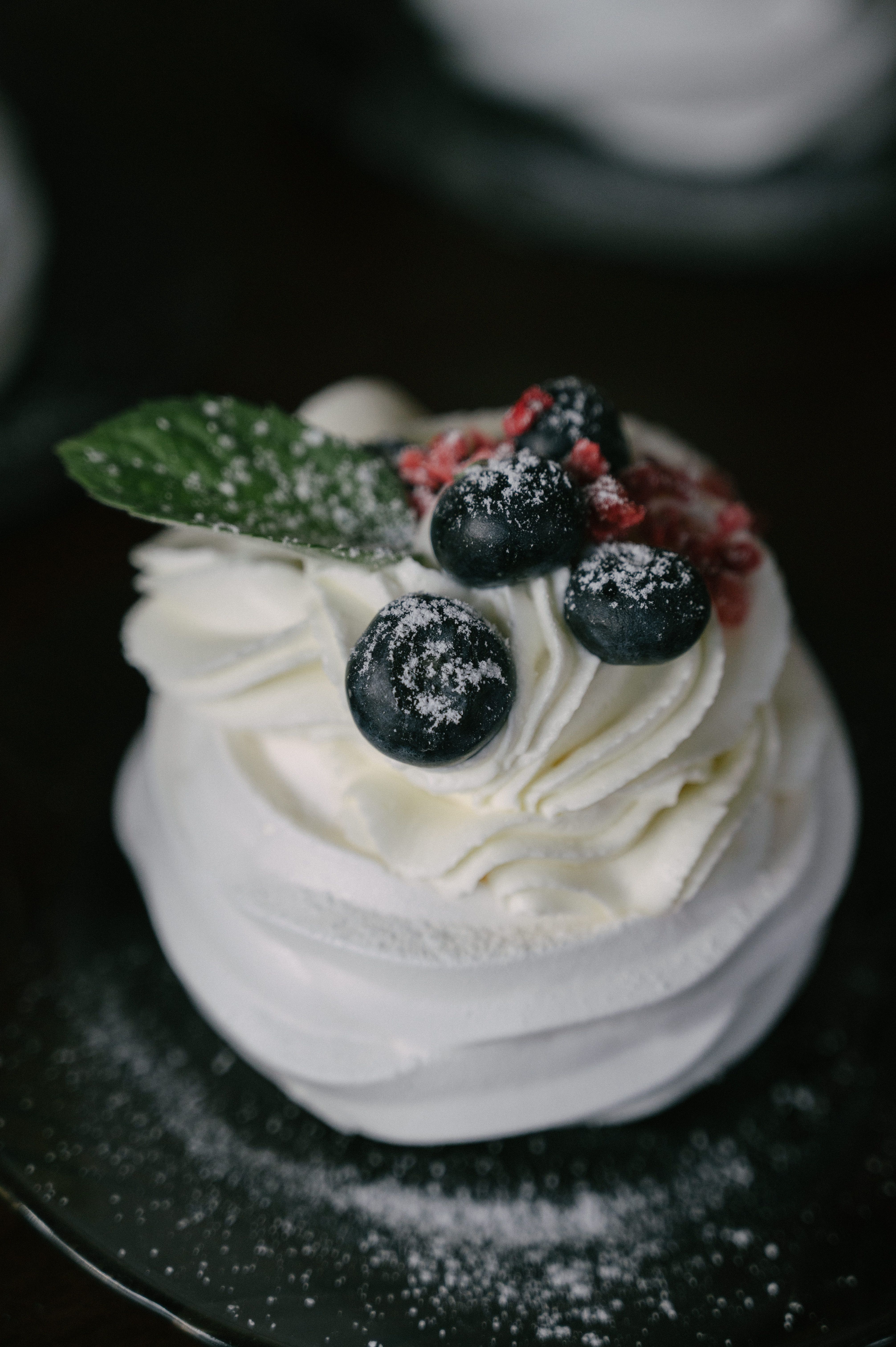 Gourmet pavlova topped with blueberries and cream, perfect for elegant soirees.