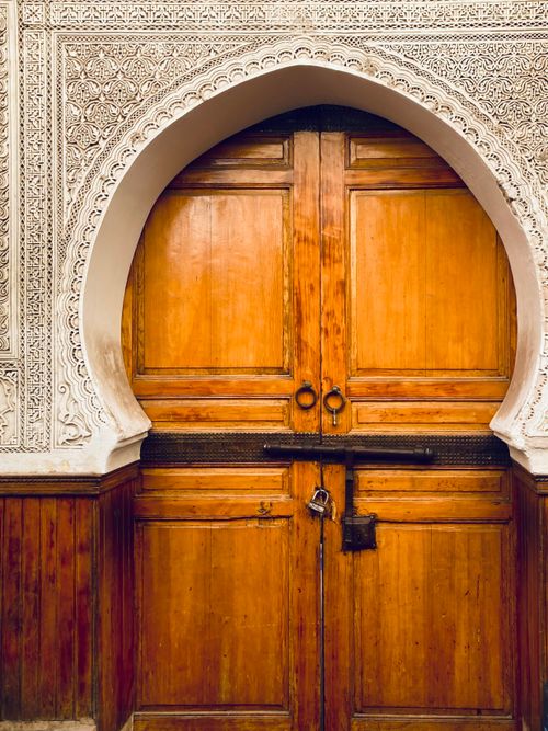 Free Detailed view of an ornate wooden doorway in Fes, Morocco, showcasing intricate Islamic architecture. Stock Photo