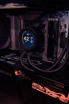 Close-up of high-performance gaming PC with liquid cooling system and RGB lighting.