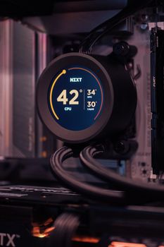 Close-up view of a modern computer cooling system with temperature display.