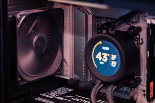 Close-up of a gaming PC build showcasing GPU, fan, and liquid cooling system.