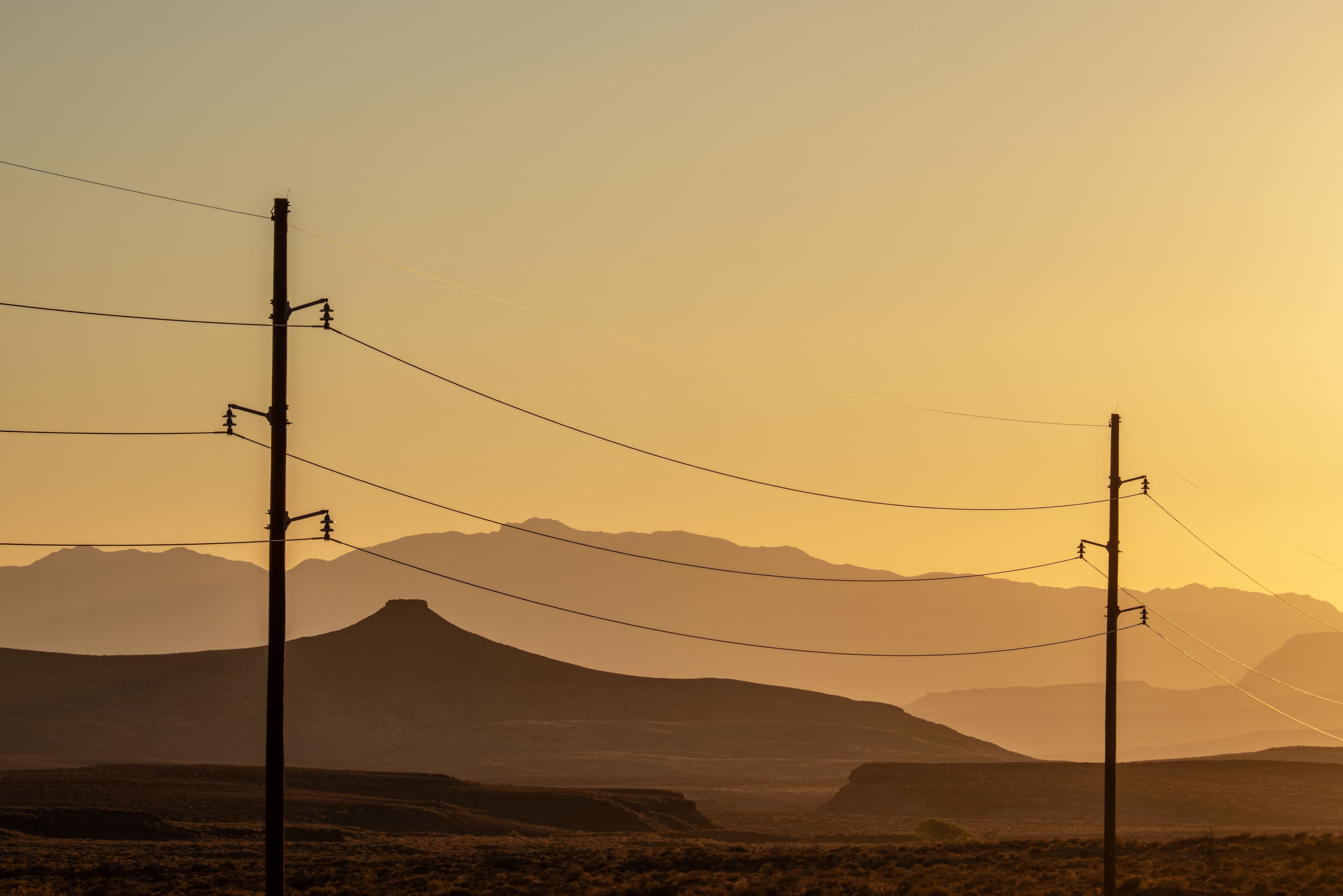 Power Lines Against Scenic Sunset in Desert · Free Stock Photo