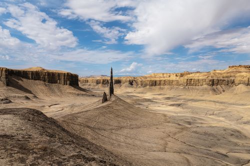 Free Breathtaking view of a unique rock formation in a vast desert landscape under a bright sky. Stock Photo