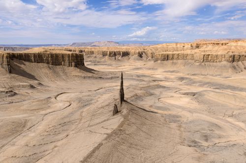 Free Stunning view of Utah's badlands featuring a unique rock formation under a clear blue sky. Stock Photo