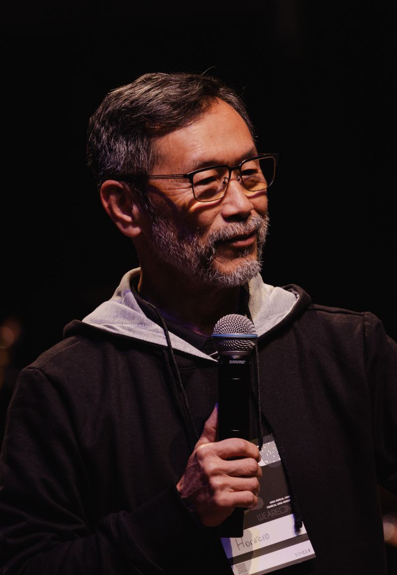Public speaker addressing an audience from a stage