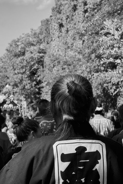 Free Black and white photo of a traditional festival with a focus on a person wearing cultural attire. Stock Photo