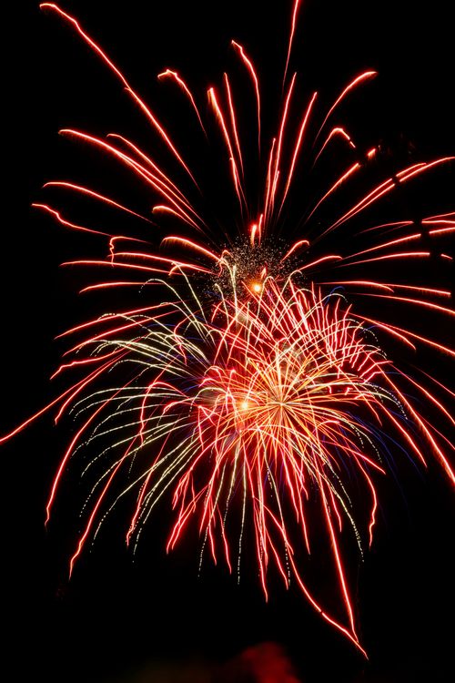 Free A stunning burst of colorful fireworks illuminates the night sky, creating a spectacular visual display. Stock Photo