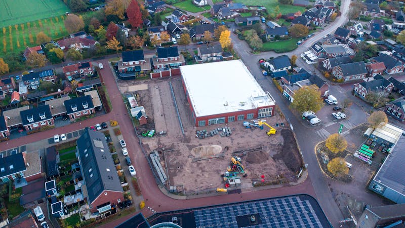 Aerial view of a residential neighbourhood with multiple homes in various stages of framing under construction