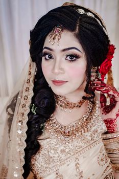 Beautiful South Asian bride in intricate bridal wear with stunning henna details.
