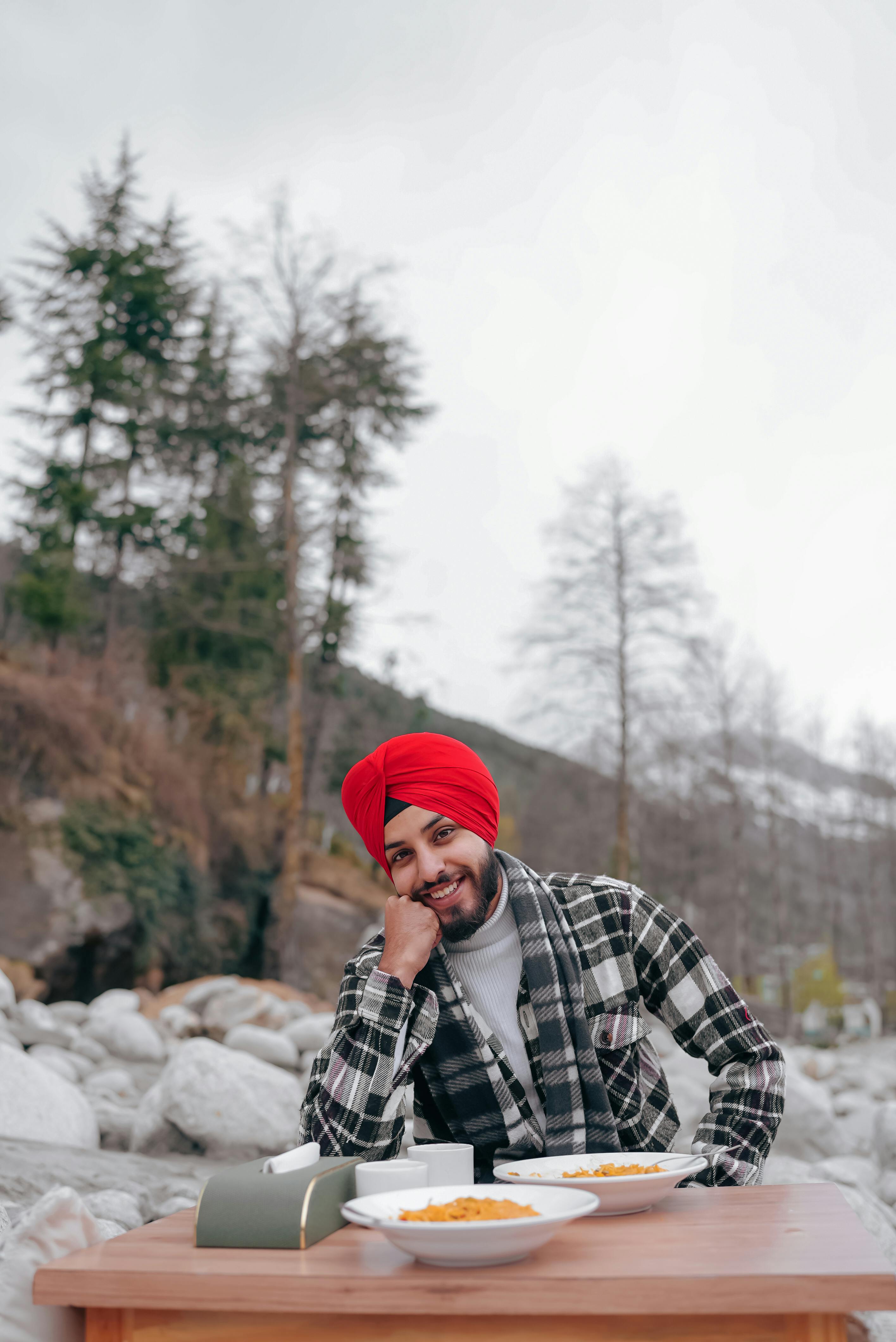Enjoying a relaxing meal outdoors amidst Manali's stunning winter landscape.