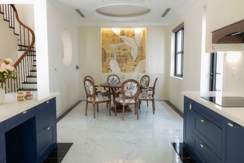 Free Stylish dining room with classic chairs and modern decor in a bright, spacious interior. Stock Photo