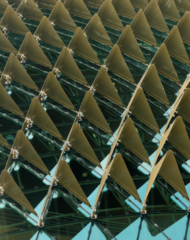 Close-up of a modern architectural facade featuring a geometric pattern with triangular elements.